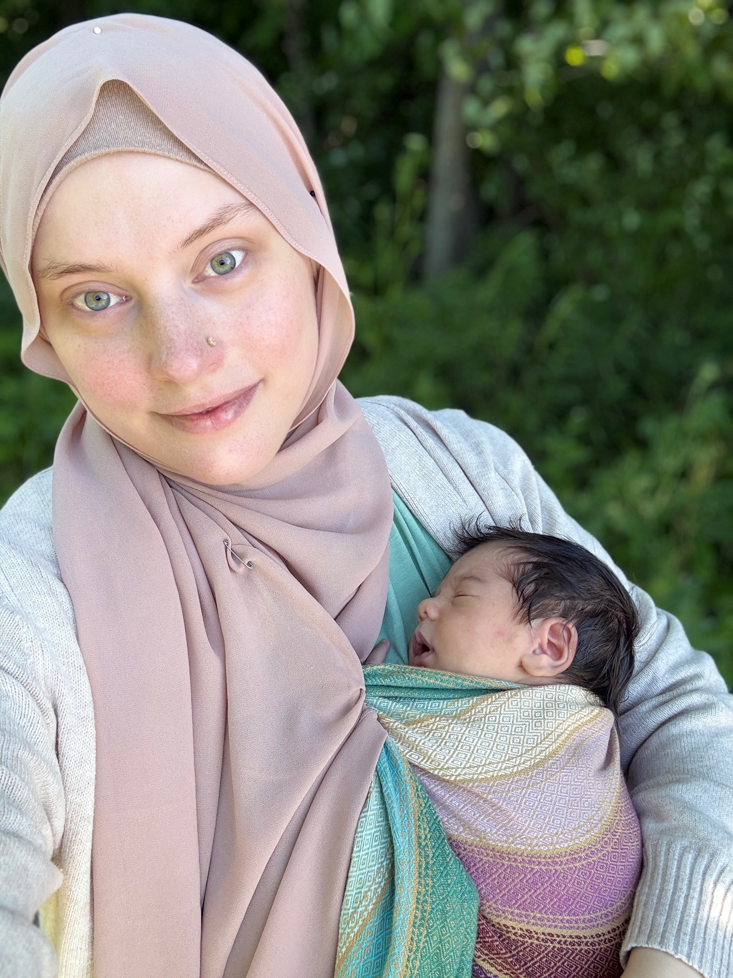Hannah, founder of Mamta Collective, holding a newborn